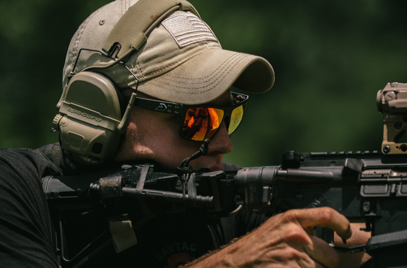 Shooter behind a red dot optic, tight profile