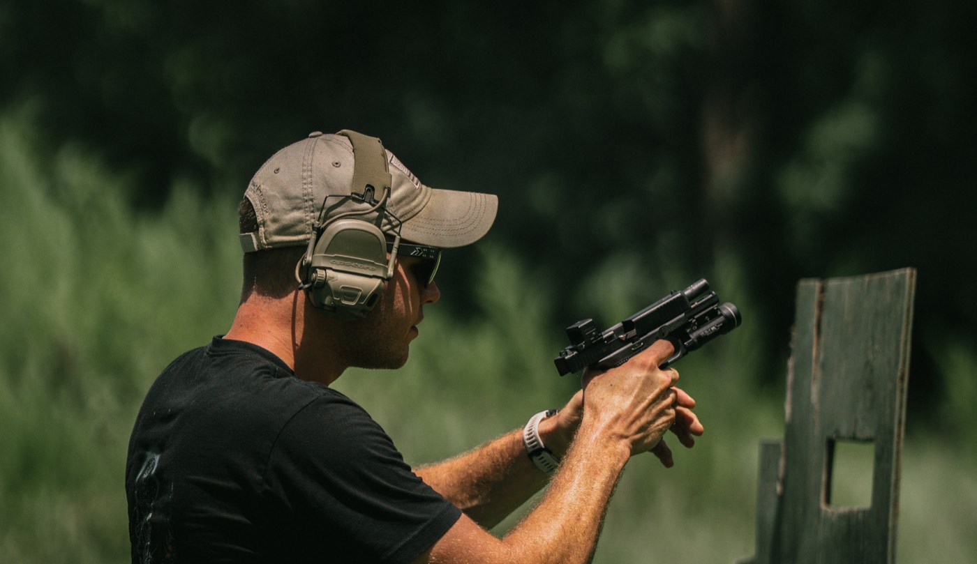 Shooter firing a pistol on the range