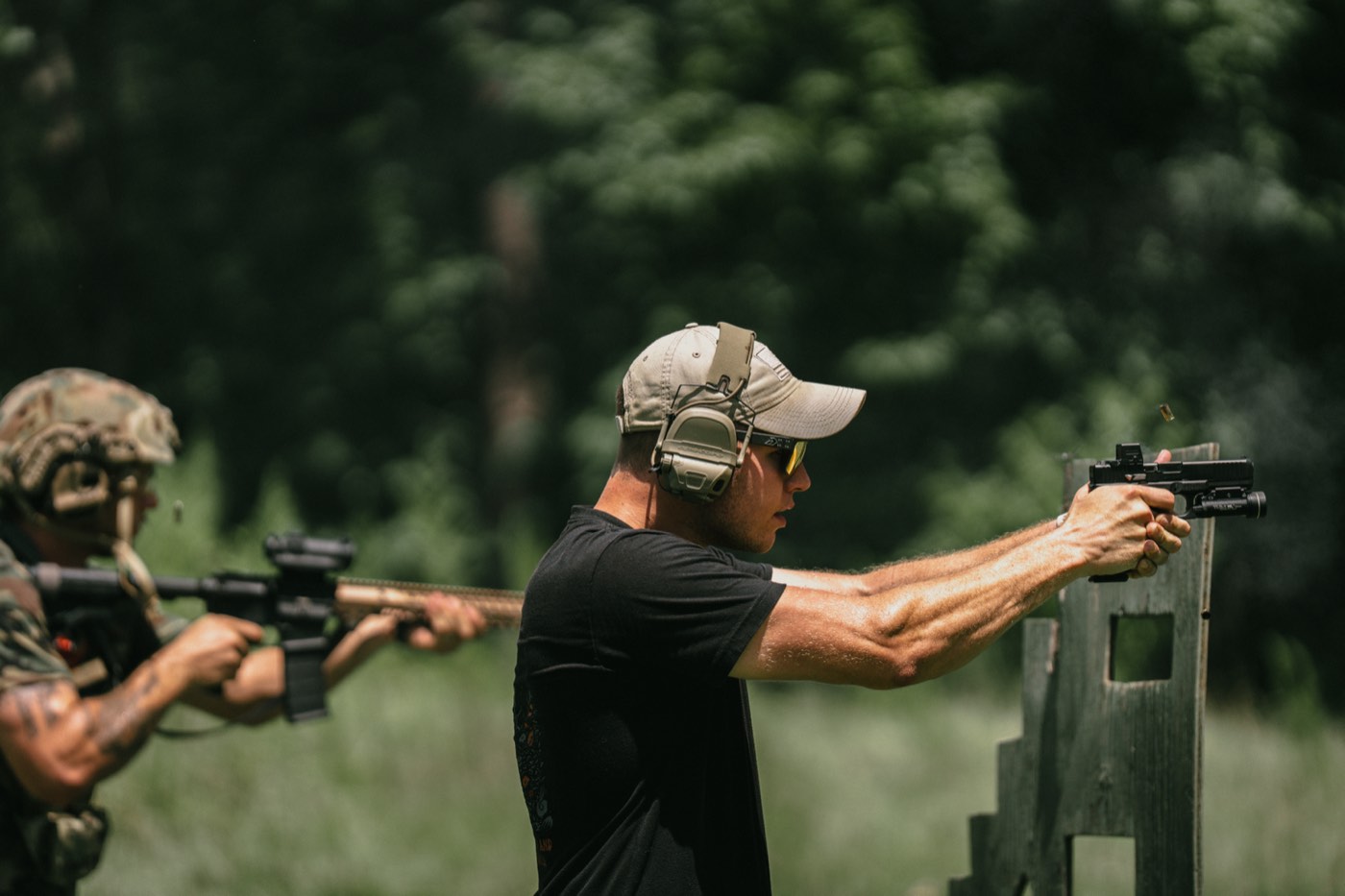 Two shooters working a barricade with pistols